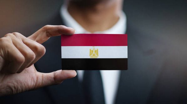 Businessman Holding Card of Egypt Flag
