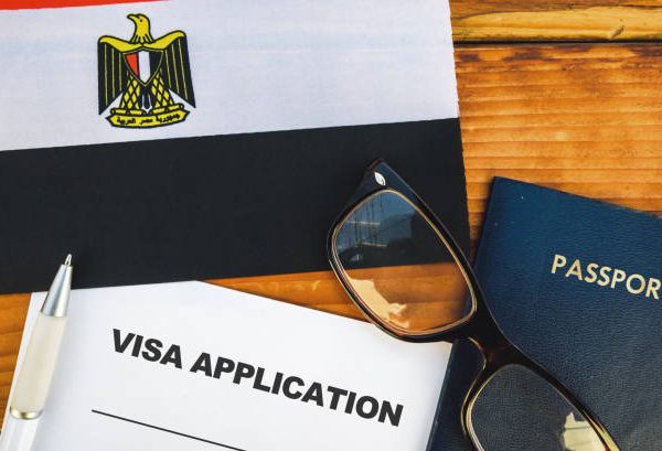 Flag of Egypt , visa application form and passport on table